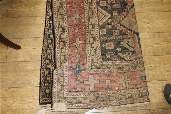 A Caucasian rug with triple medallion on a blue ground and two worn Persian rugs 210 x 120cm, 205 x 135cm and 195 x 145cm